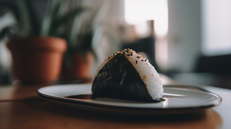 吃个🍙高端的食材往往只需要最简单的做法：1080p, delicious Onigiri, on a plate, on a table, bokeh, shot on iphone --ar 16:9 --v 5